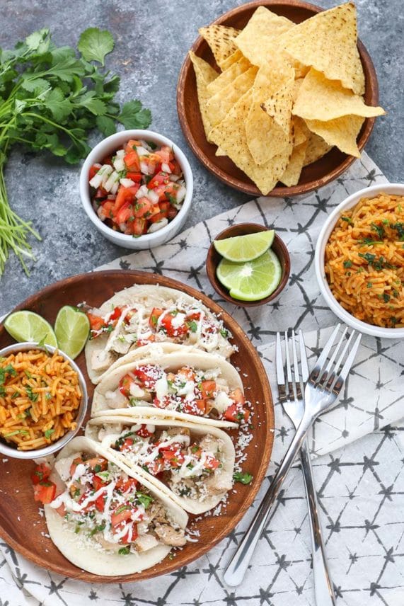 Adding toppings to Freshly made Cilantro Lime Chicken Tacos