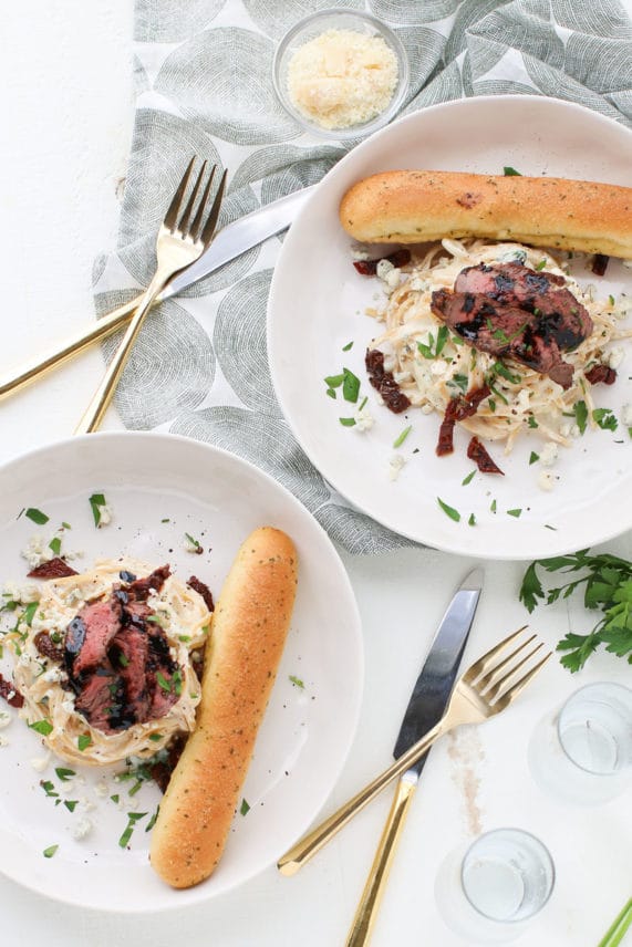 Serving hot plates of Steak and Blue Cheese Alfredo