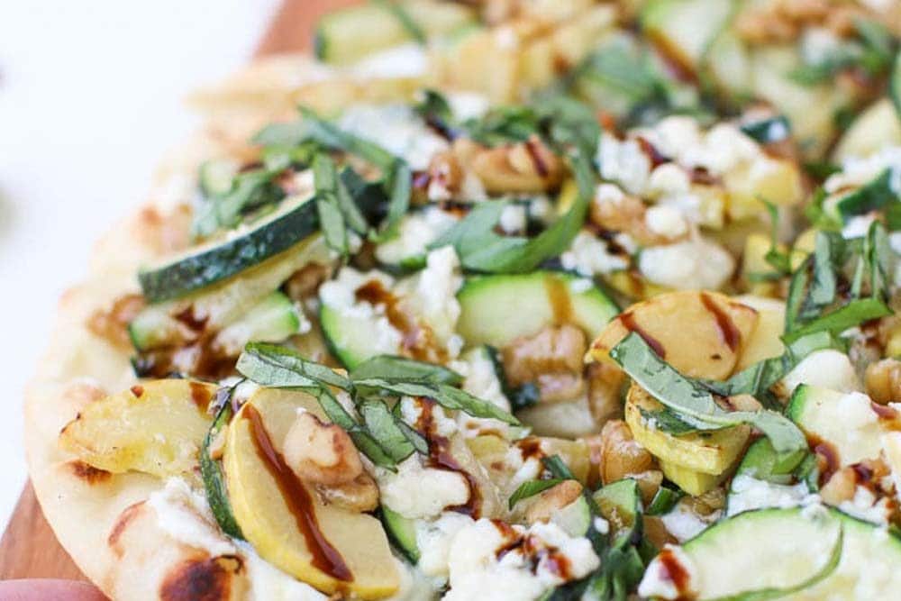 Grabbing a piece of Summer Squash and Blue Cheese Flatbread