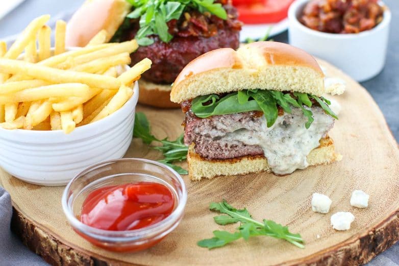 Freshly served Blue Cheese Stuffed Burger and fries