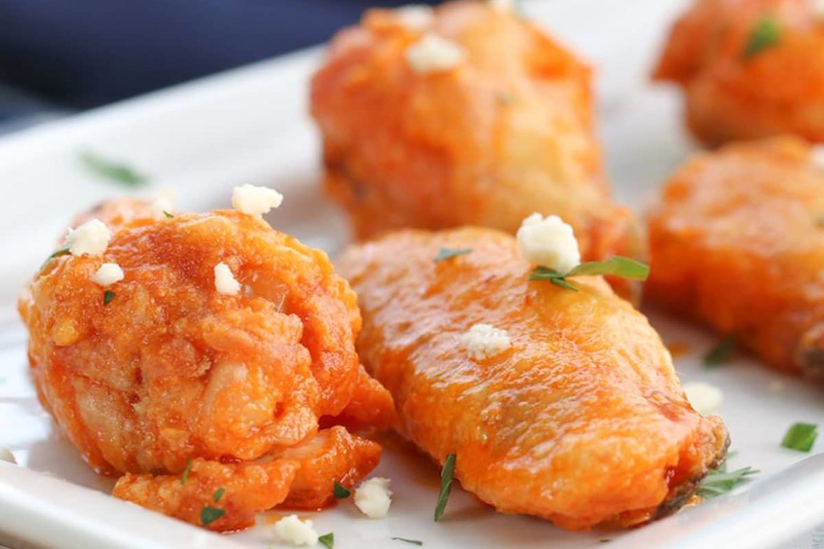 Preparing a batch of Crispy Baked Buffalo Chicken Wings