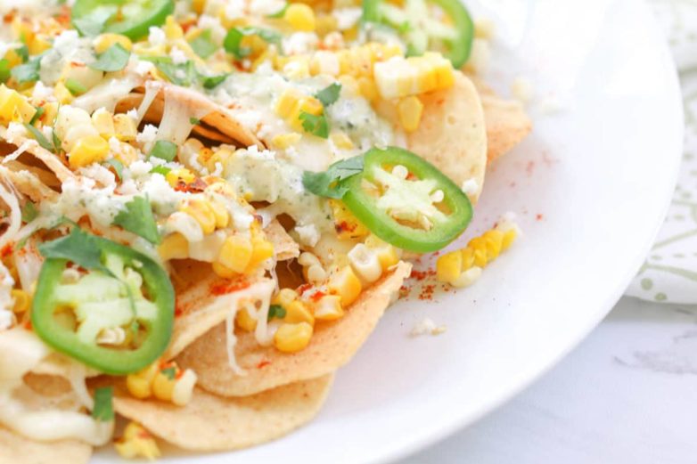 Sizzling plate of Mexican Street Corn Nachos