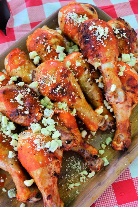 Topping Grilled Buffalo Chicken Drumsticks with Blue Cheese Crumbles