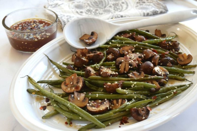 Sesame Ginger Roasted Green Beans & Mushrooms on a platter with Litehouse Sesame Ginger Dressing