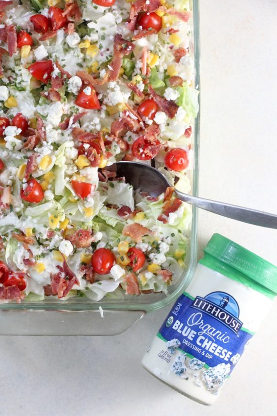 Scooping out Layered Wedge Salad with Bacon & Blue Cheese