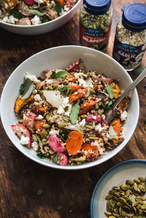 Adding Litehouse Freeze Dried herbs to Honey Mustard Roasted Root Quinoa Salad