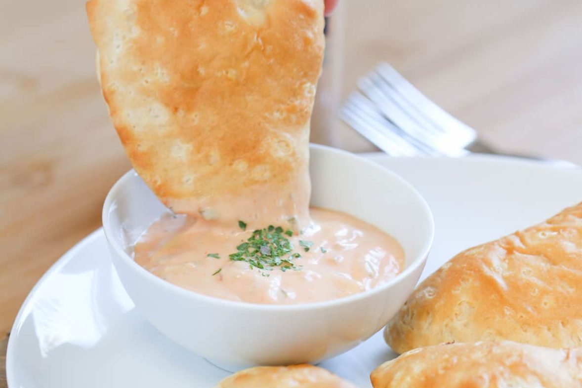 Dipping a Biscuit Wrapped Reuben Sandwich