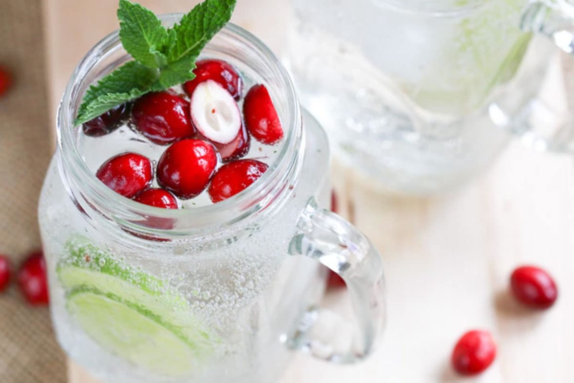 Adding cranberries to a Winter Cranberry Mojito