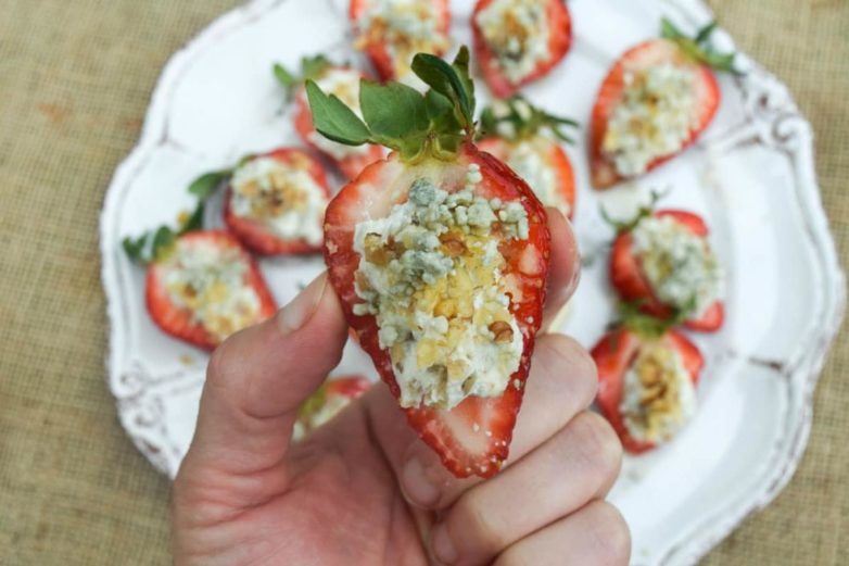 Taking a bite of Blue Cheese & Walnut Stuffed Strawberries