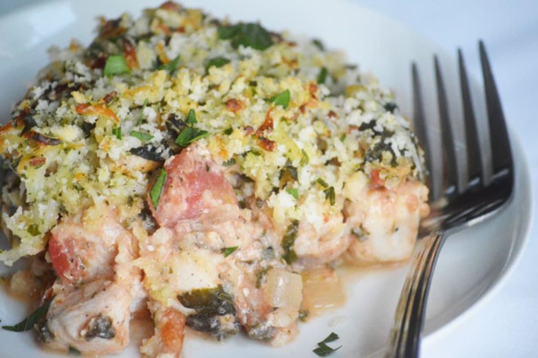 Taking a bite of Creamy Bruschetta Chicken Bake