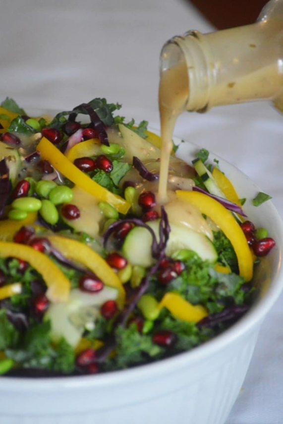 Drizzling a little dressing on Confetti Kale Salad